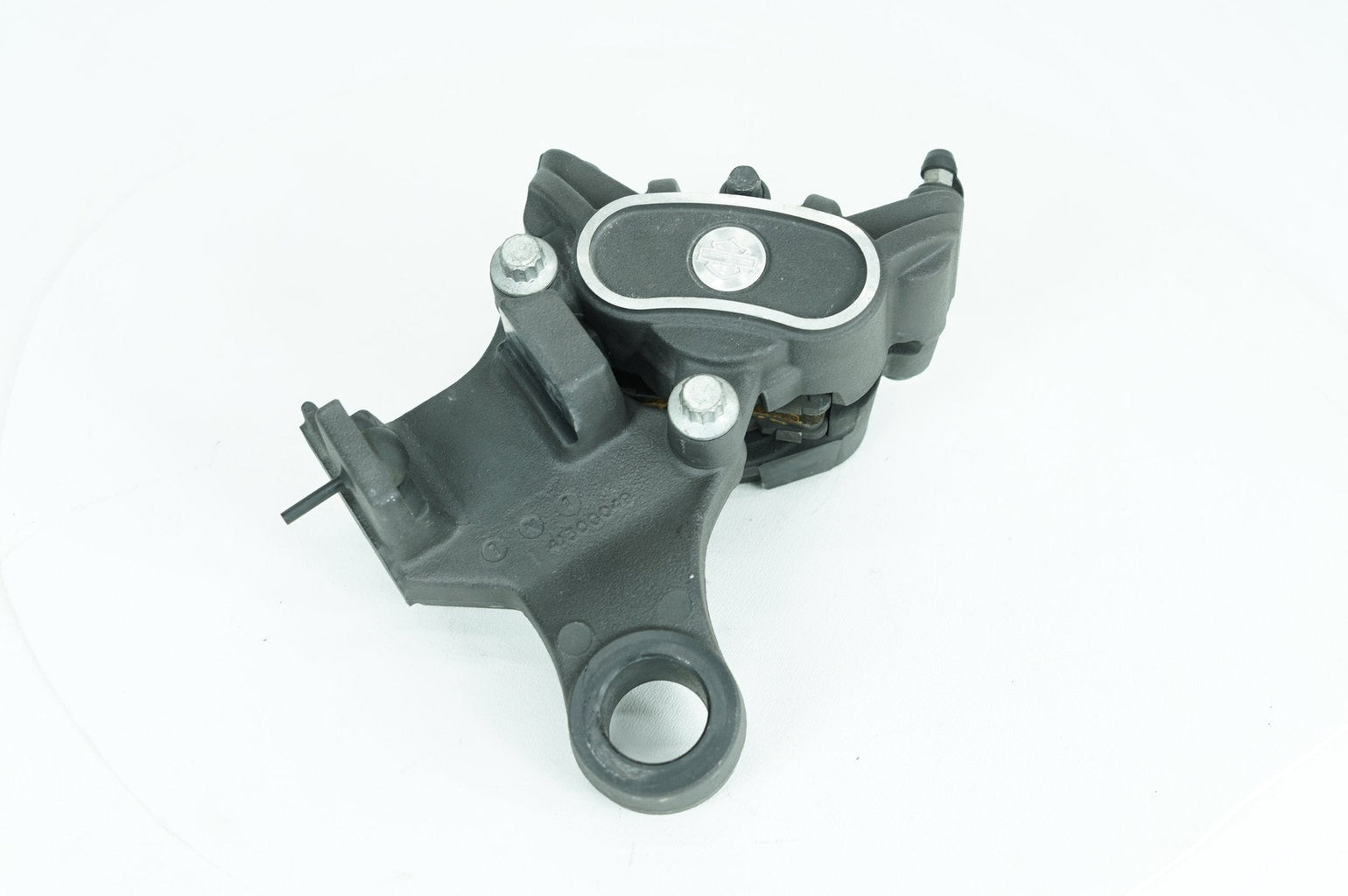 Used Harley-Davidson rear brake caliper with bracket at Exclusive Harley Parts
